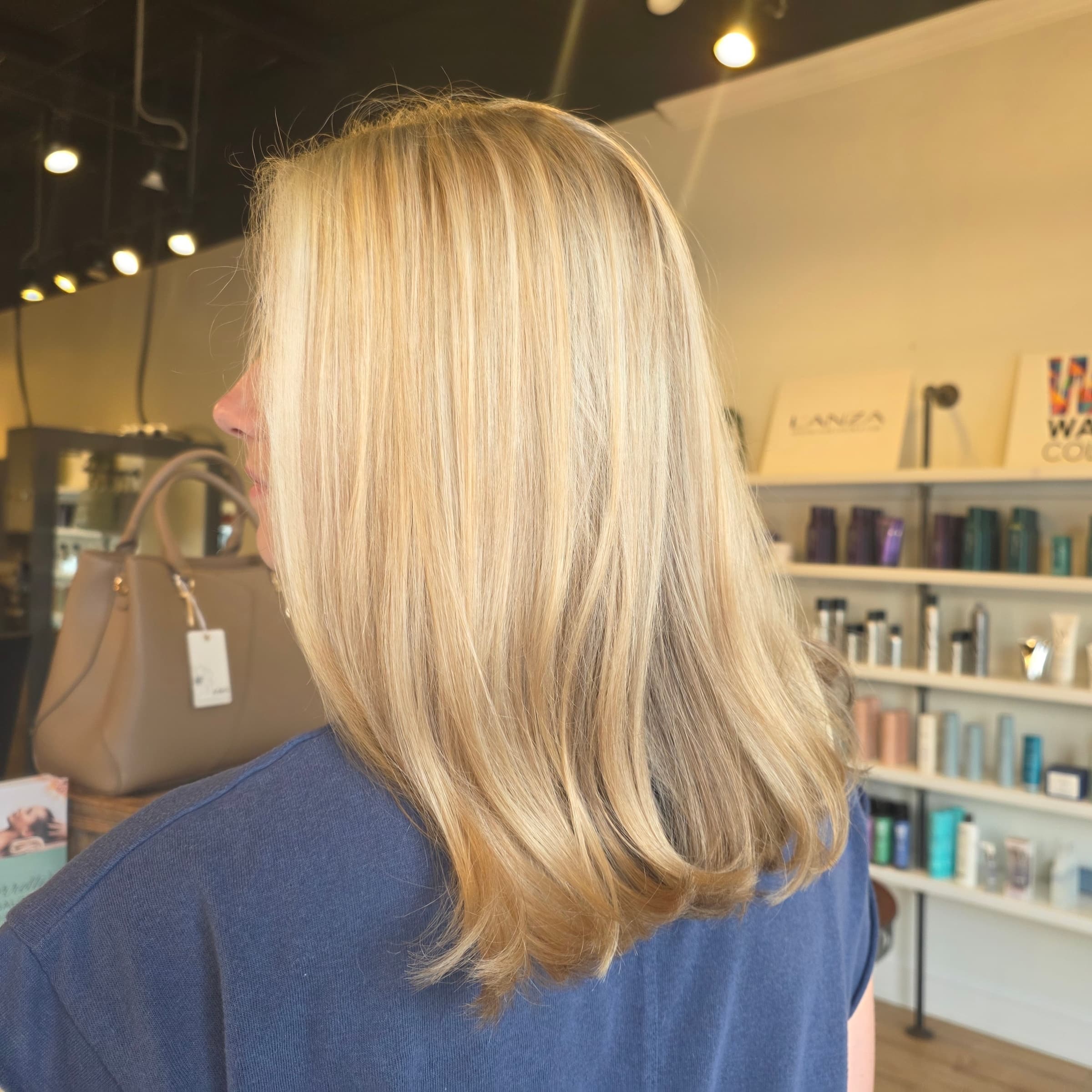 Blonde color correction taken to an even, bright result — hair by Lili Barker in Leander, TX