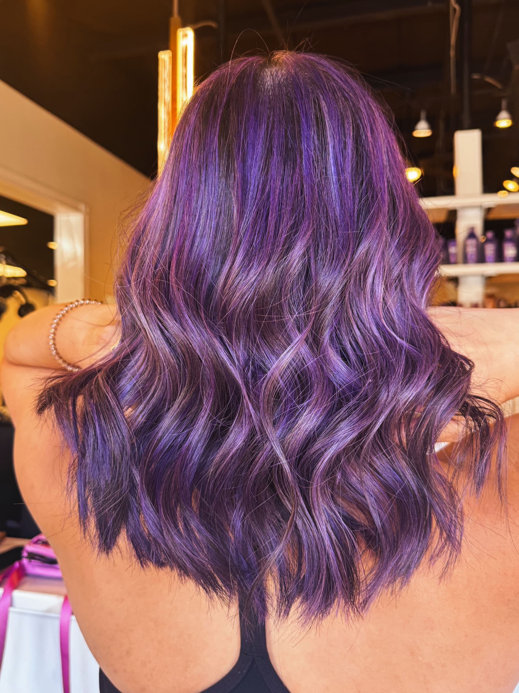 Layered cut with a bouncy blowout finish — hair by Lili Barker in Leander, TX