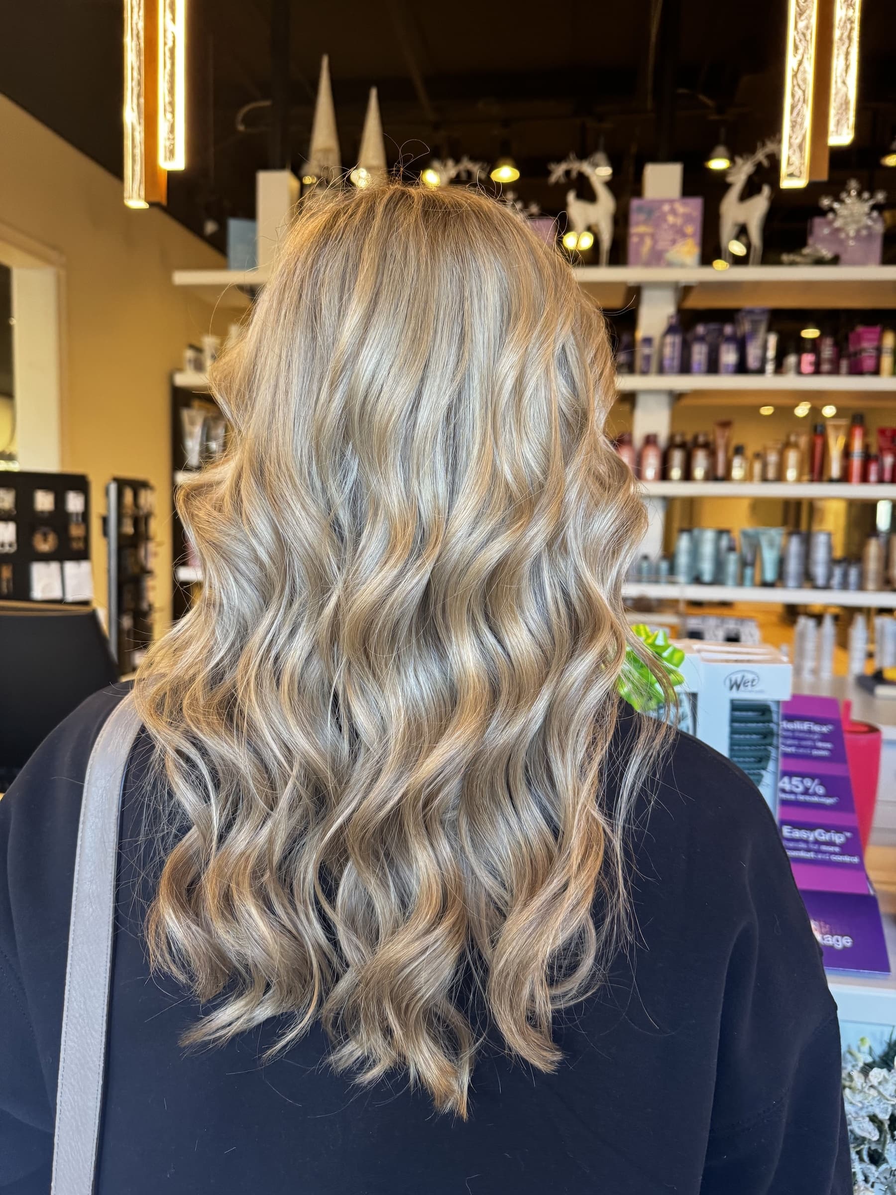 Layered cut with a bouncy blowout finish — hair by Lili Barker in Leander, TX