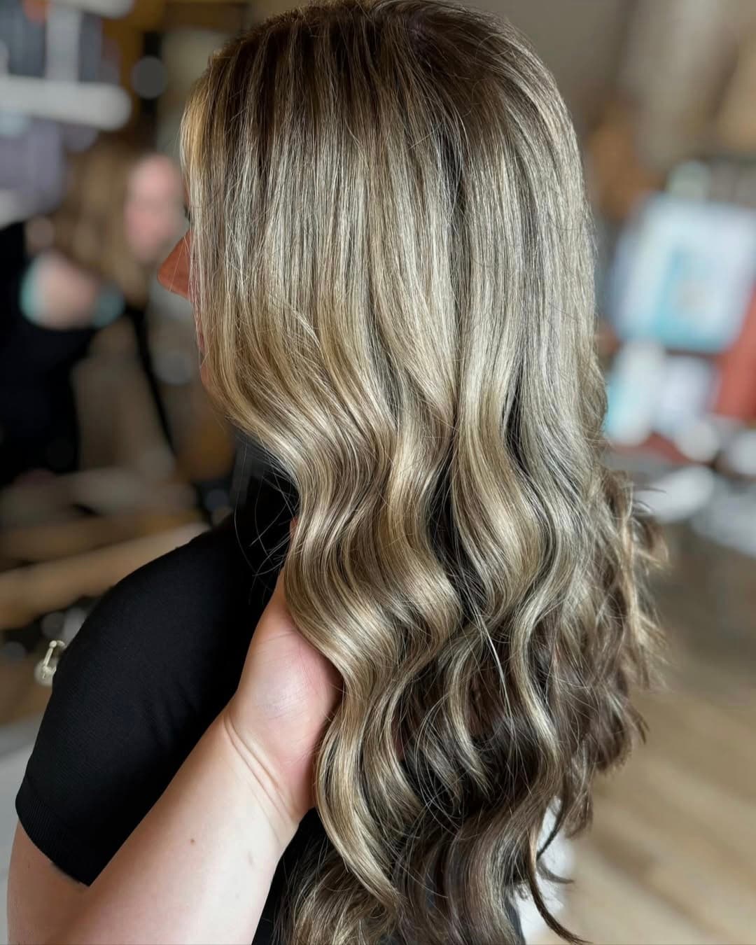 Dimensional blonde highlights finished with a gloss — hair by Lili Barker in Leander, TX
